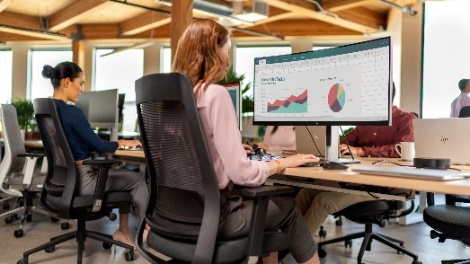 A person sitting at a desk
Description automatically generated